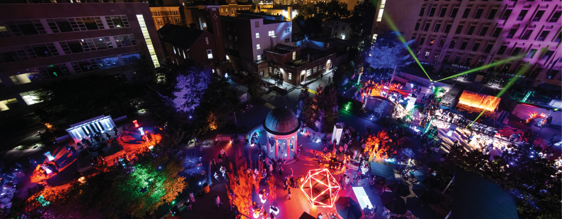 Kogan Plaza lit up for bicentennial bash. Students and other attendees can be seen walking through the plaza.