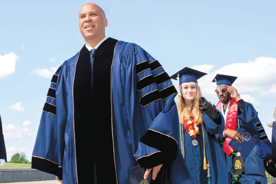 Cory Booker taking the stage at commencement