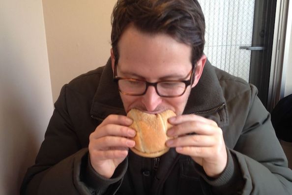 Adam Chandler eating burger