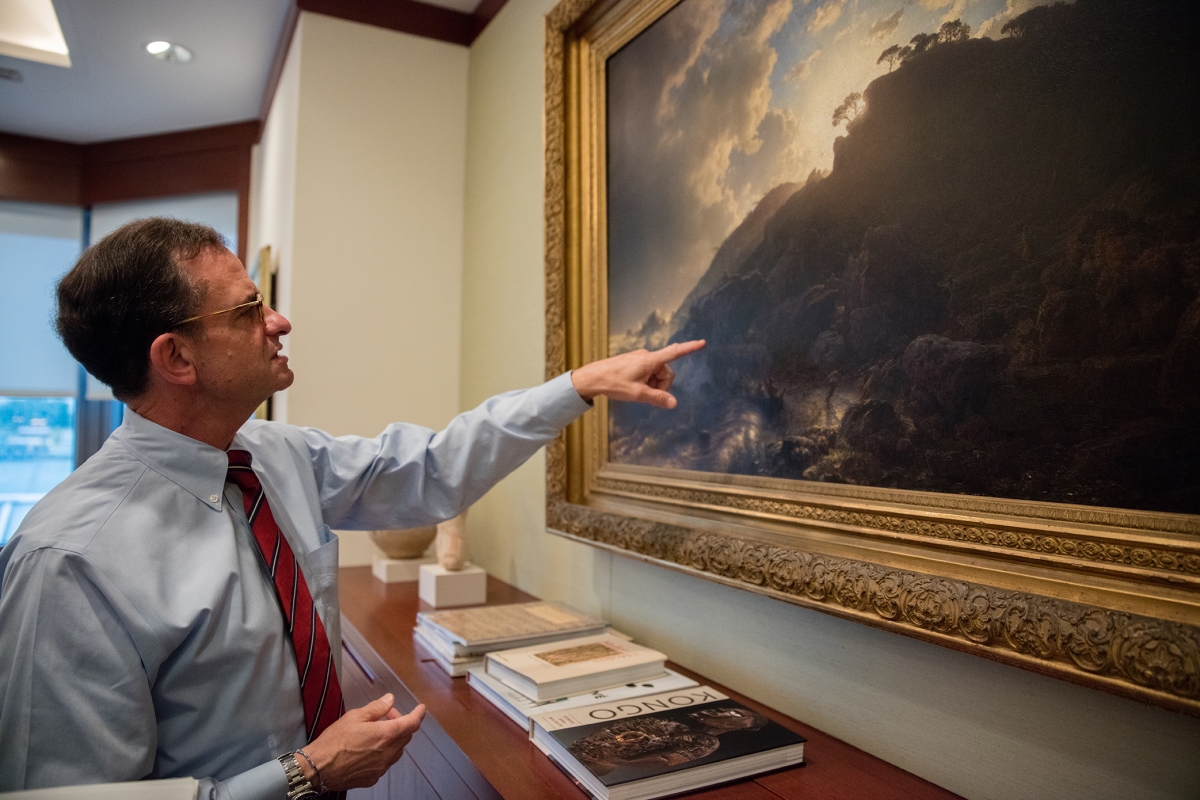 Dr. Weiss musing about details in an Andreas Achenbach painting in his office