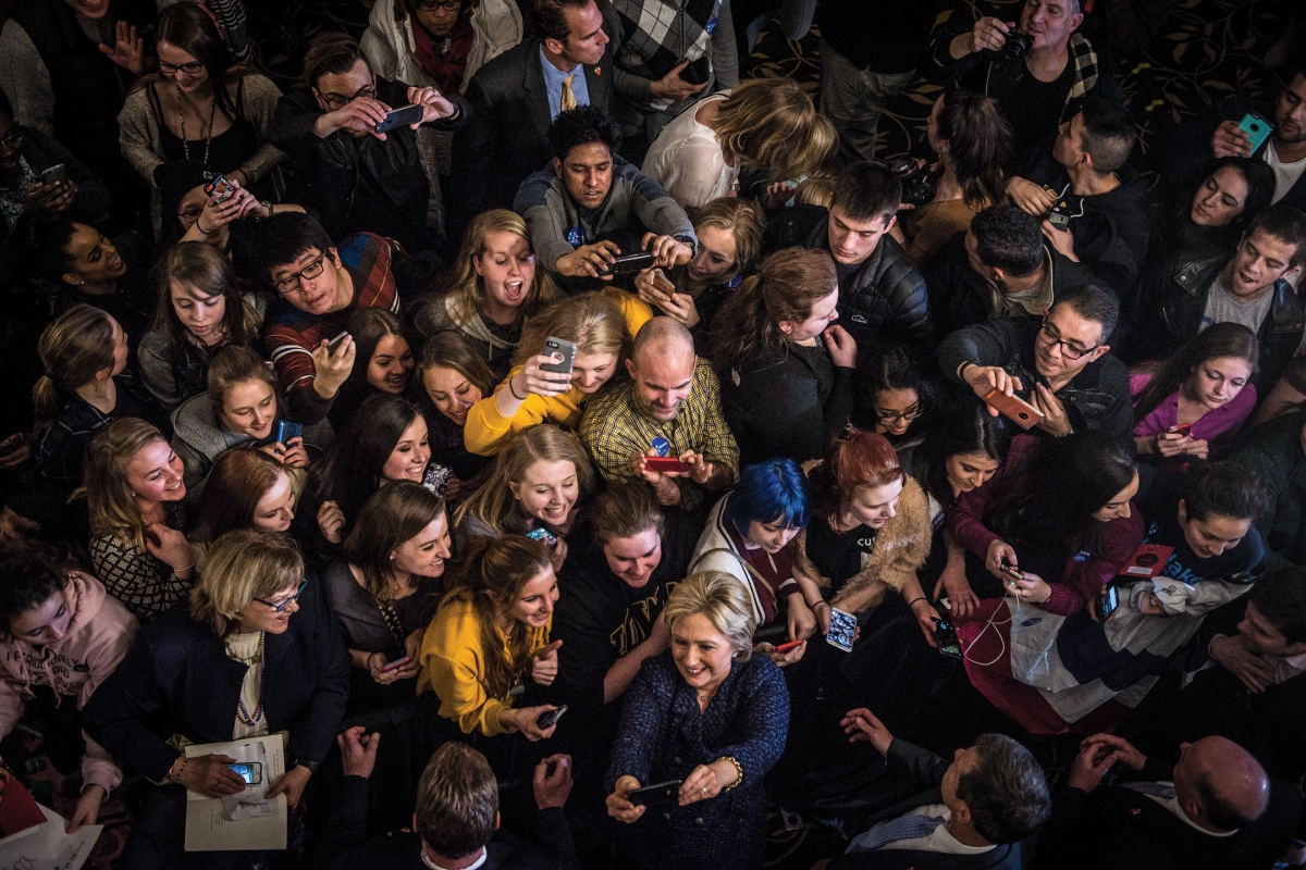 Hilary Clinton taking a selfie with a large group of people
