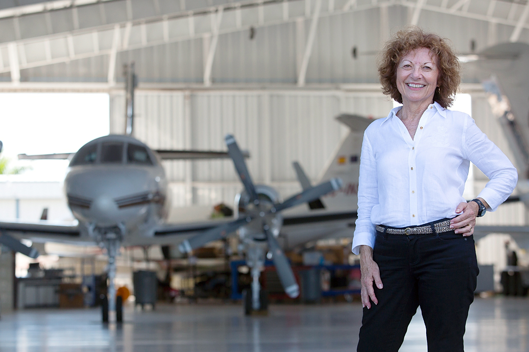 Jane standing in front of airplane