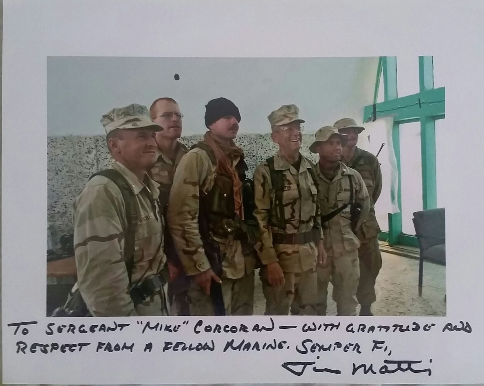 Mike Corcoran (black skullcap) poses with Gen. James Mattis, the future secretary of defense, and fellow Marines in Afghanistan in 2001. The photo is signed by Mattis. (Rob Curtis)s