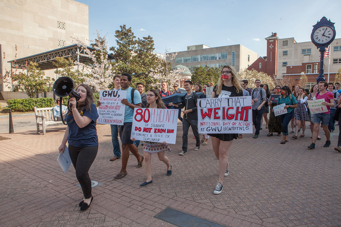 Student carries a sign that reads carry that weight at the national day of action