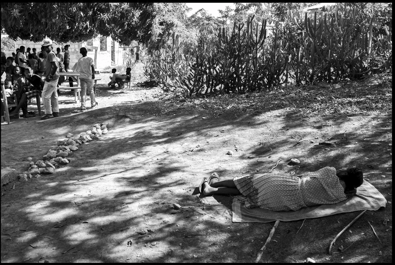 black and white photo of a woman laying on the ground