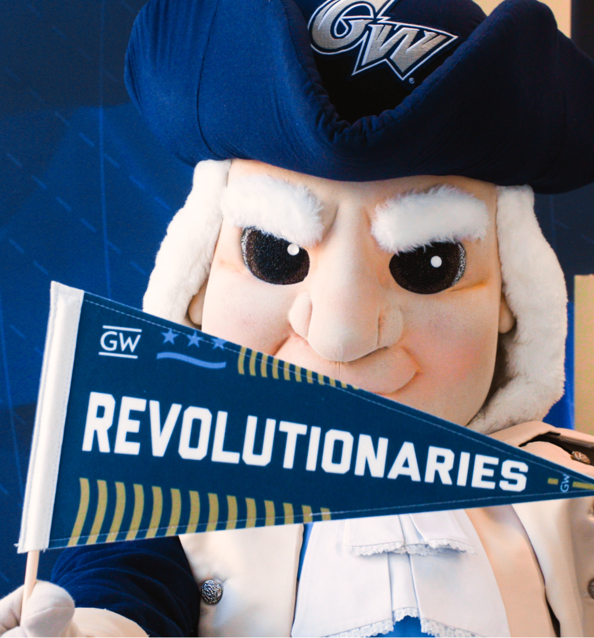 The George Washington mascot holds a "Revolutionaries" pennant