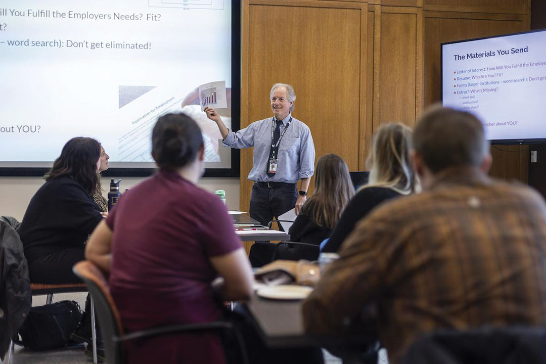 Director John Wetenhall speaking to a classroom of people