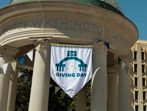 A Giving Day flag waves on the GW Tempietto