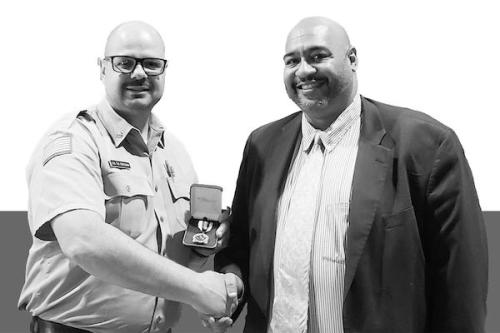 Mike Corcoran accepts the medal of valor from John Wetzel, the Pennsylvania secretary of corrections