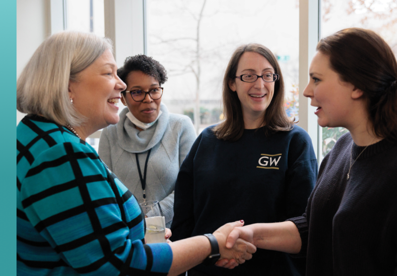 Granburg shaking hands with female student
