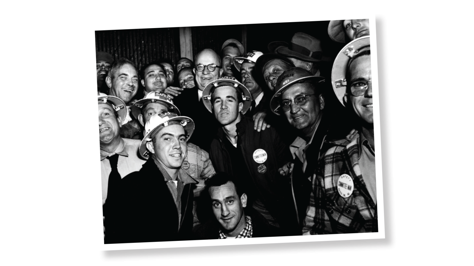Union members in hard hats surrounding Henry Kaiser (top center)