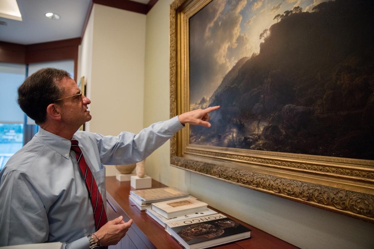 Dr. Weiss musing about details in an Andreas Achenbach painting in his office