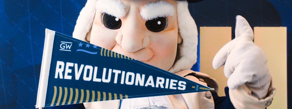 The George Washington mascot holds a "Revolutionaries" pennant